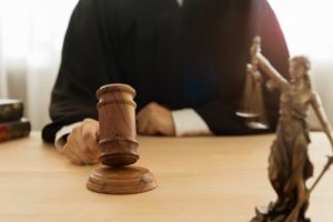 Male judge hitting a gavel in a courtroom.