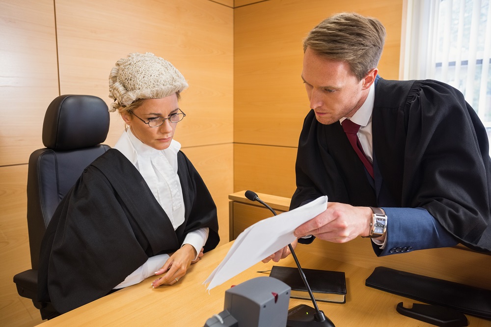 Lawyer speaking with the judge in the court room.