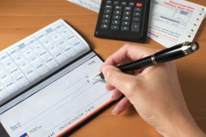 Man writing checks for payment.