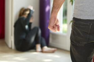 Man beating his wife showing domestic violence.