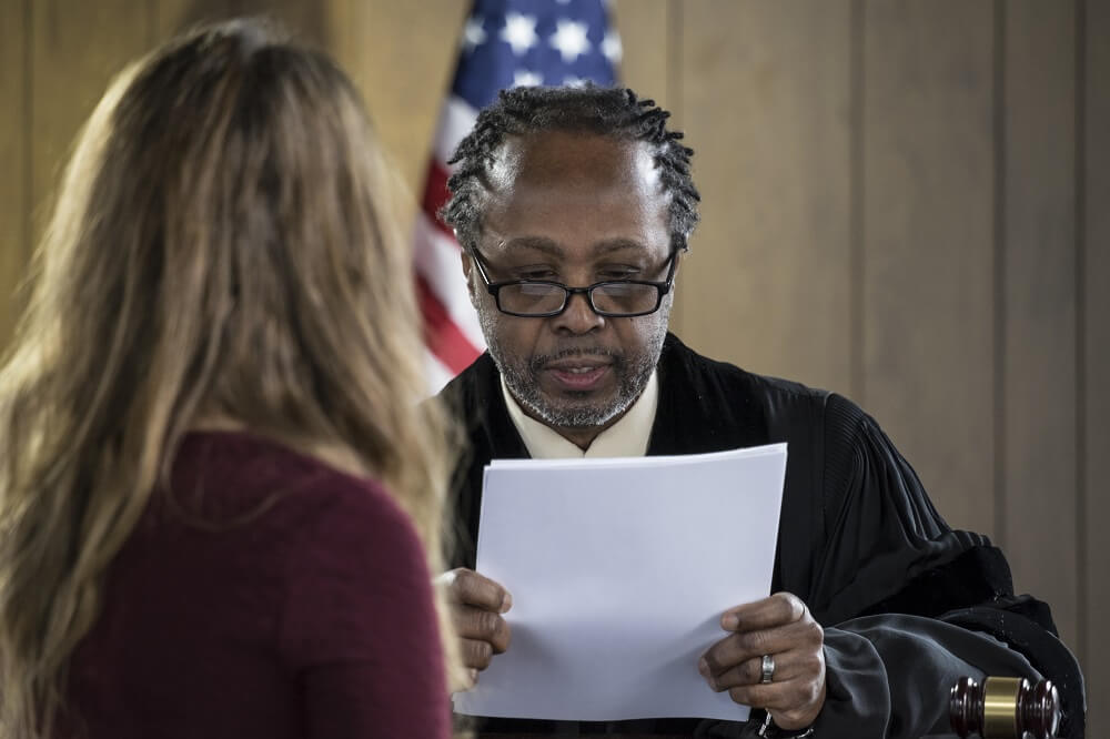 Woman talking to the judge in court.