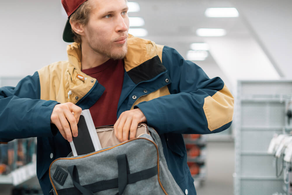 Thief stealing gadget at the store.